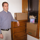 Ward Buell stands beside the dresser that sparked Estes’ memory.